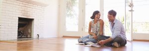 Couple reading magazines on floor