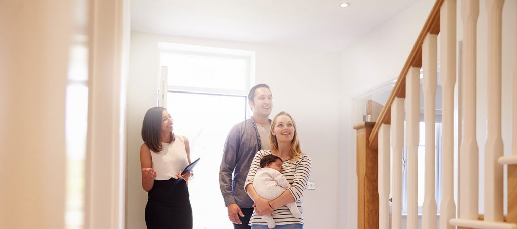 Young family inspecting home