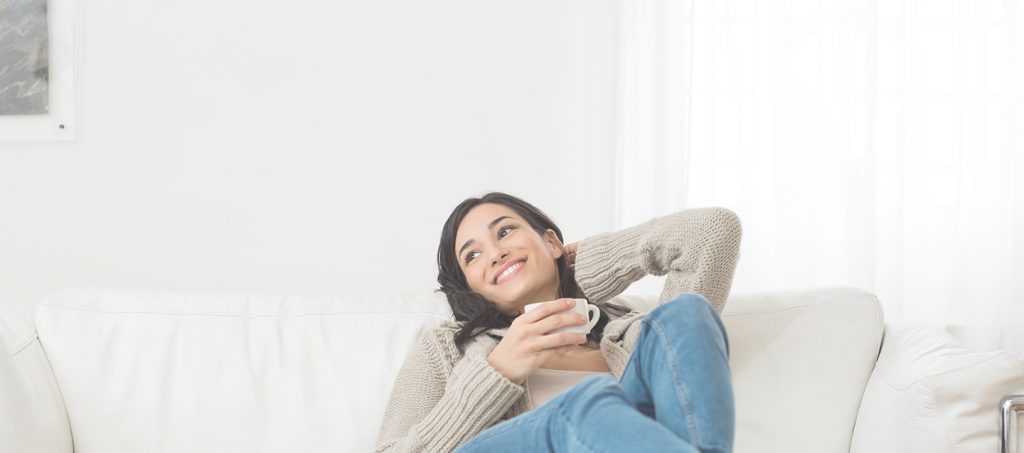 woman relaxing on couch with mug